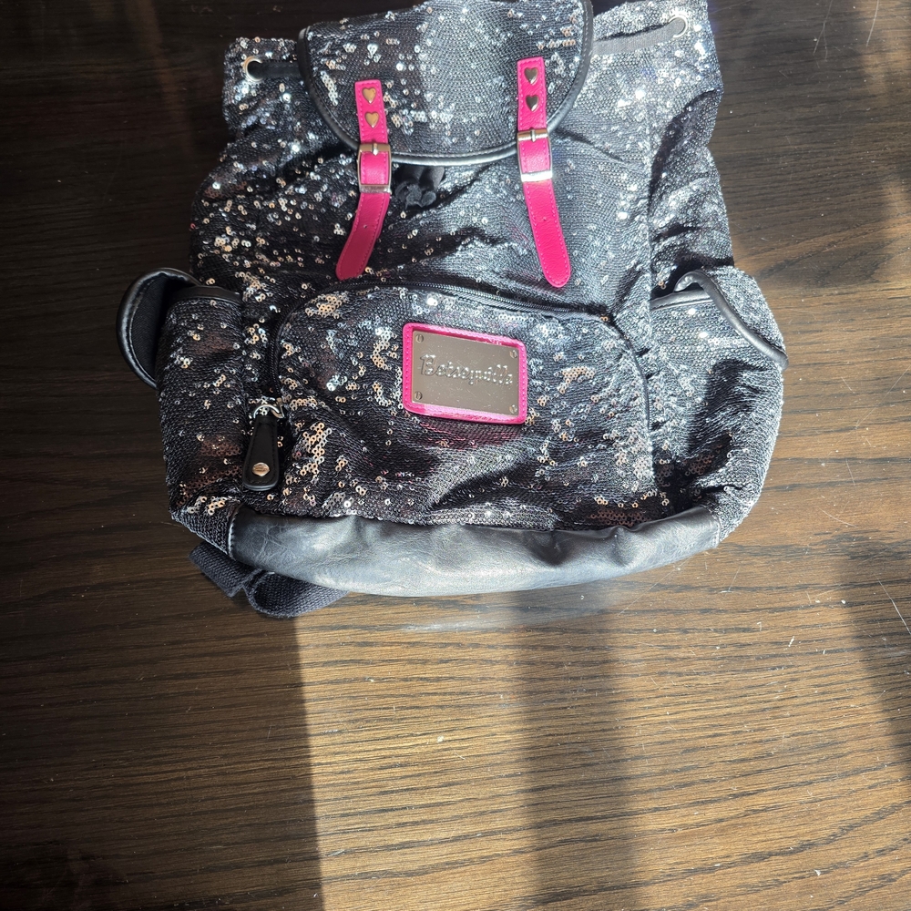 Betseyville by Betsey Johnson black sequin backpack with pink accents.